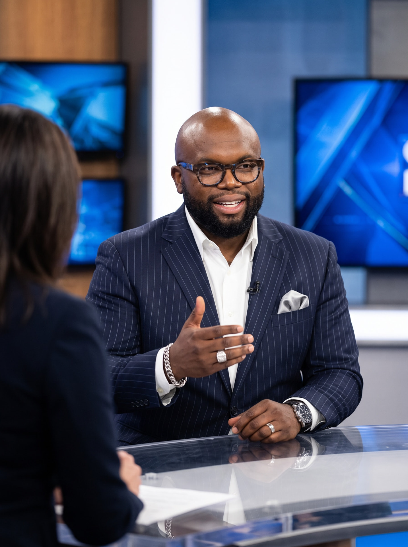Oscar L. Frazier being interviewed in a TV studio